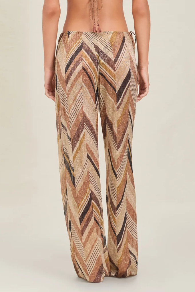 Patterned pants worn by a person on a plain background