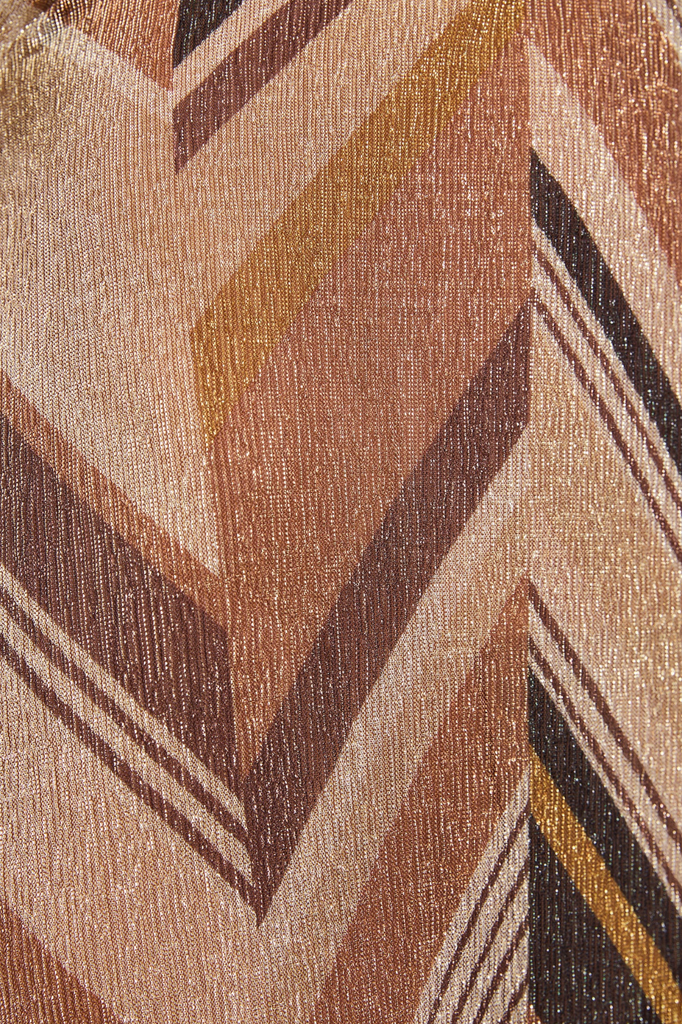 Close-up of a textured fabric with brown and beige chevron pattern