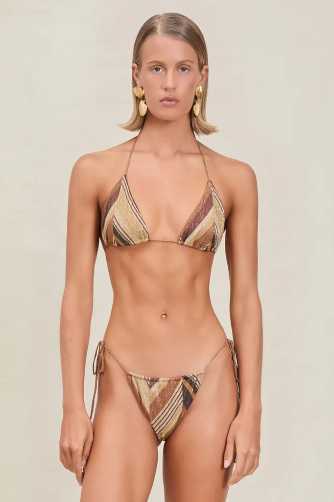 Model wearing a patterned bikini set against a neutral background
