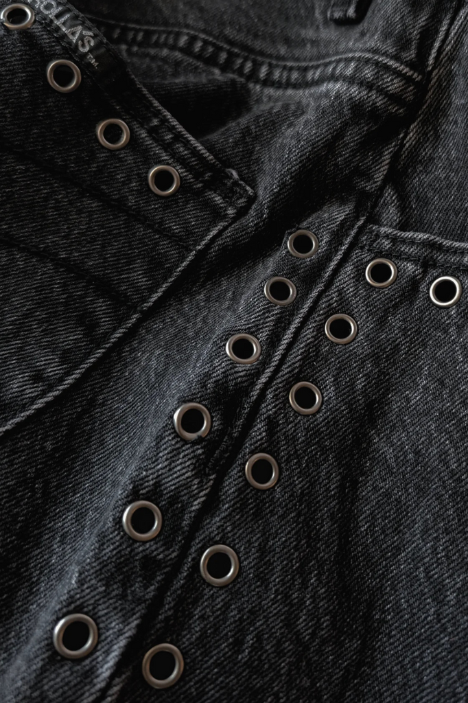 Washed black denim jeans with eyelet detailing