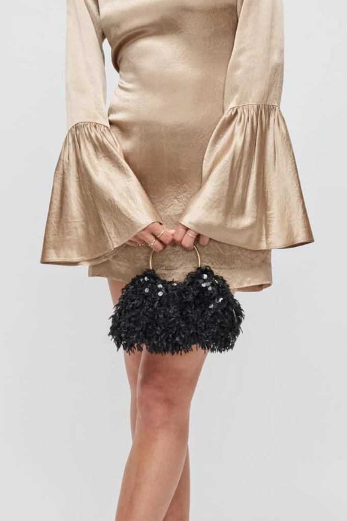 Black evening bag adorned with feathers and sequins