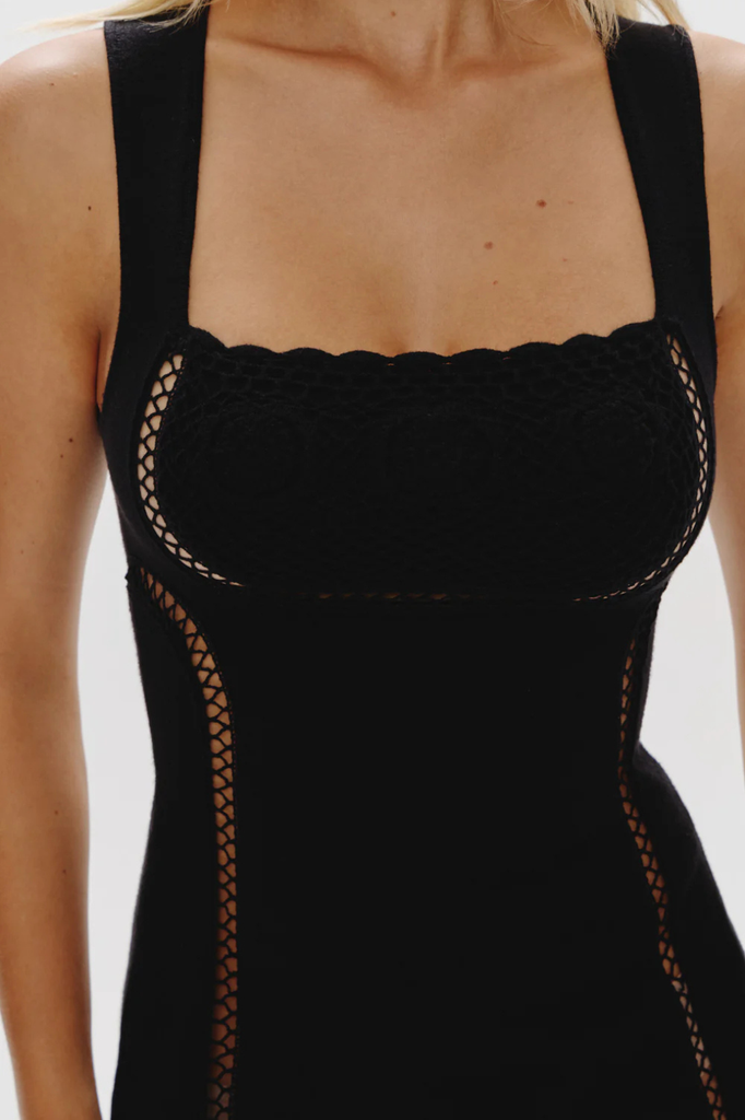 Sleeveless little black mini dress with peekaboo stitching detail throughout