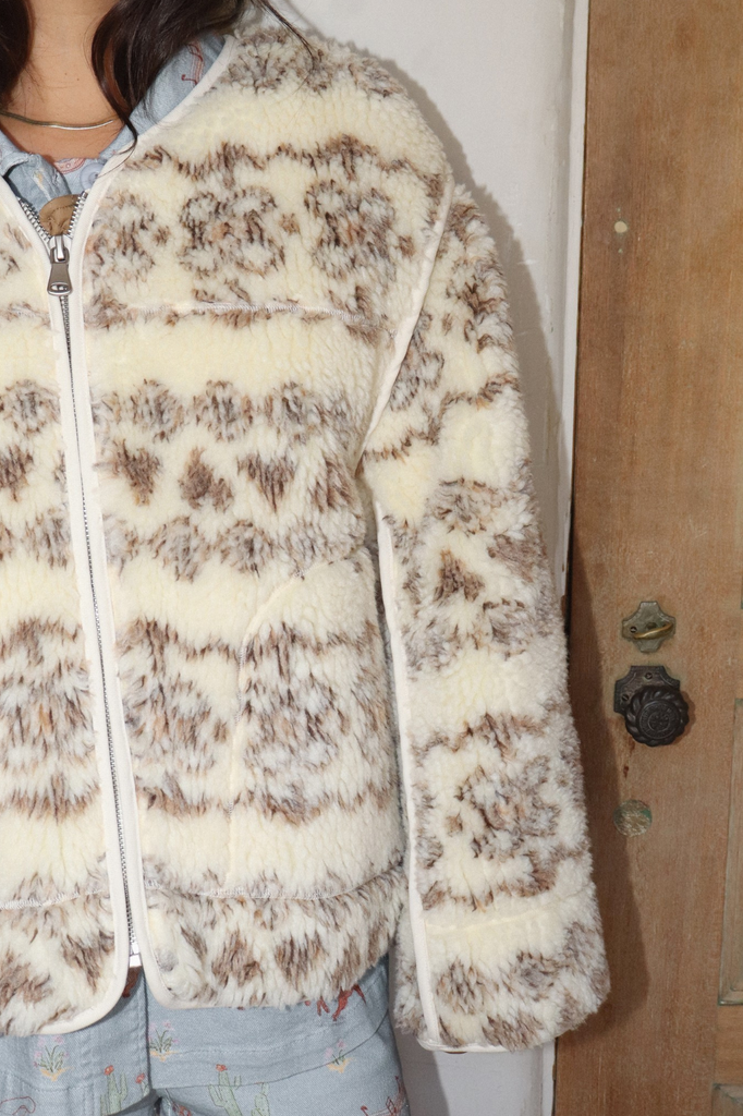 Creamy colored fuzzy zip-up sherpa jacket with a brown tonal fair isle pattern