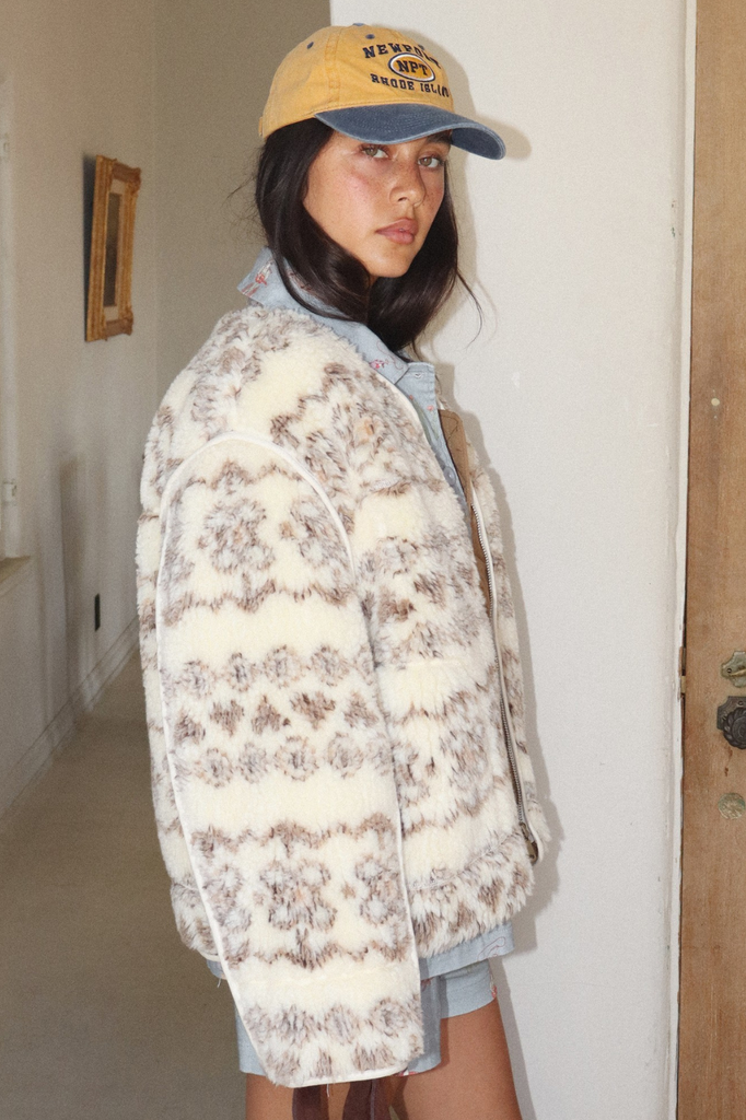 Creamy colored fuzzy zip-up sherpa jacket with a brown tonal fair isle pattern