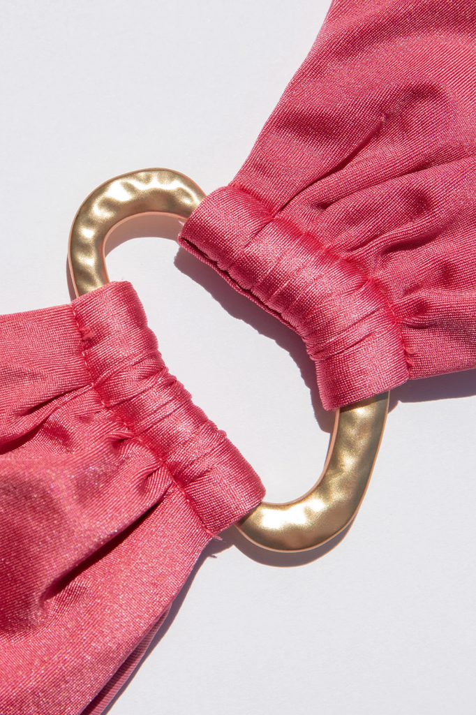 Pink satin bikini top with a hammered gold ring at center bust.&nbsp;