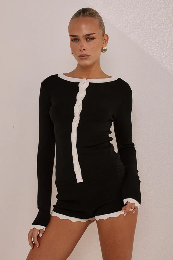 Black long sleeve knit cardigan with white contrast detailing